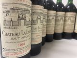 several bottles of wine are lined up on a table