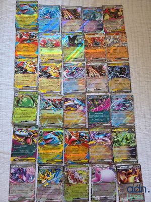 a pile of pokemon cards sitting on top of a table