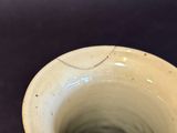a close up of a white vase on a table