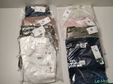 two bags of men ' s shirts are sitting on a table