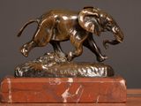 a bronze statue of an elephant on a marble base