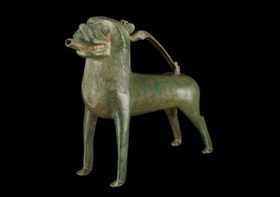 bronze statue of a dog on a black background with a black background