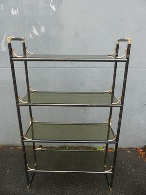 a metal and glass shelf with four shelves on top of it