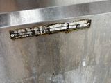 a close up of a stainless steel refrigerator with a thermometer on it