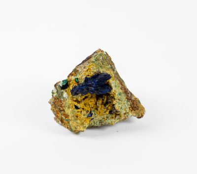 a close up of a piece of rock with blue and yellow crystals