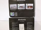 two boxes of electronic appliances sitting on top of a white table