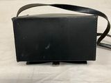 an image of a black purse sitting on top of a white table