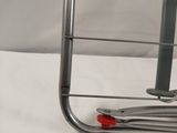 a metal rack with a pair of scissors on top of it