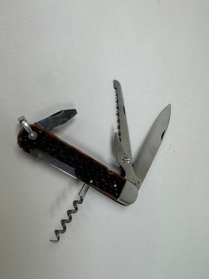 a small swiss army knife with a corkscrew on it