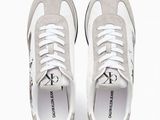 the white sneakers are on a white surface with white laces