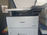 a white printer sitting on top of a black counter