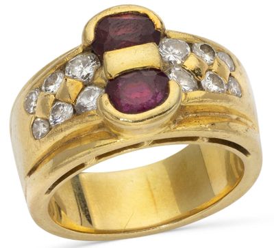a close up of a gold ring with a ruby and diamond center