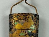 a gold and black bag hanging on a wall