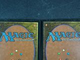 two decks of magic the gathering are on display on a table