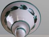 a white bowl with a green and white design on it