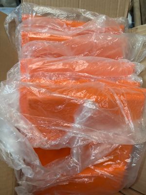 a lot of carrots wrapped in plastic on a box
