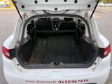 the back of a white car with its trunk open in a parking lot