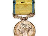 une image représentant une médaille entourée d'un ruban et la tête d'une femme