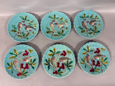 six blue plates with birds and berries on them on a table