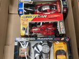 a box full of assorted toy cars and remotes