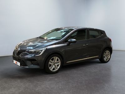 a grey car is parked in a room with a white wall