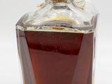 a glass bottle with a brown liquid inside of it