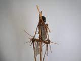 une sculpture composée de bâtons, posée sur une table