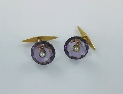 une paire de boutons de manchette violets et dorés sur un fond blanc