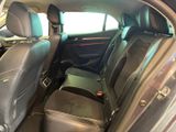 the back seats of a car with a suitcase in the passenger seat