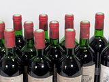 several bottles of wine are lined up in a row on a table