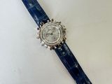 a close up of a watch on a table with a white background