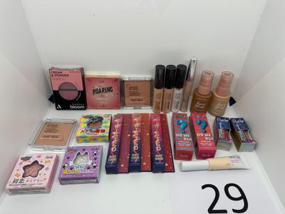 many different makeup products displayed on a table