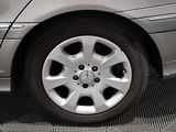 a silver car that is parked on the side of the road