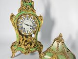 two clocks that are sitting next to each other on a table