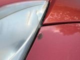 a close up of the hood of a red car