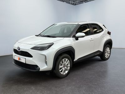 a white toyota c - hr suv parked in a garage