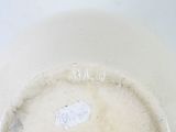a close up of a white vase with a label on it