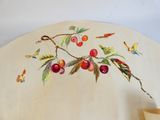 a painting of cherries on the wall of a room