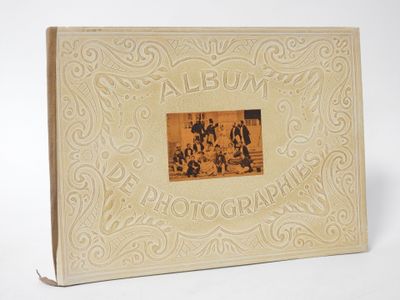 an old photo album with a picture of a group of people