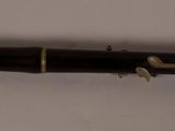 a close up of a pen on a white surface with a white background