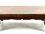 a small wooden table with a bench on top of it