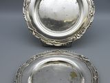 a pair of silver plated dishes on stands