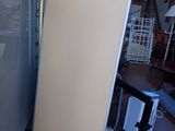 an image of a refrigerator in a warehouse with a door open