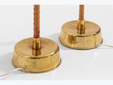 pair of brass table lamps with wooden bases and a cord
