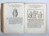 an open book with a drawing of a man holding a vase