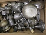 a cardboard box full of old metal items that are in it