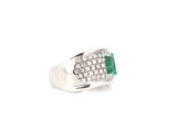 an emerald and diamond ring on a white background