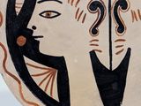 painting of a woman ' s face in a circle with a question mark on it