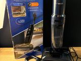 a black and silver blender sitting on a table next to a box