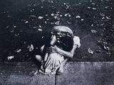 a black and white photo of a child on the sidewalk